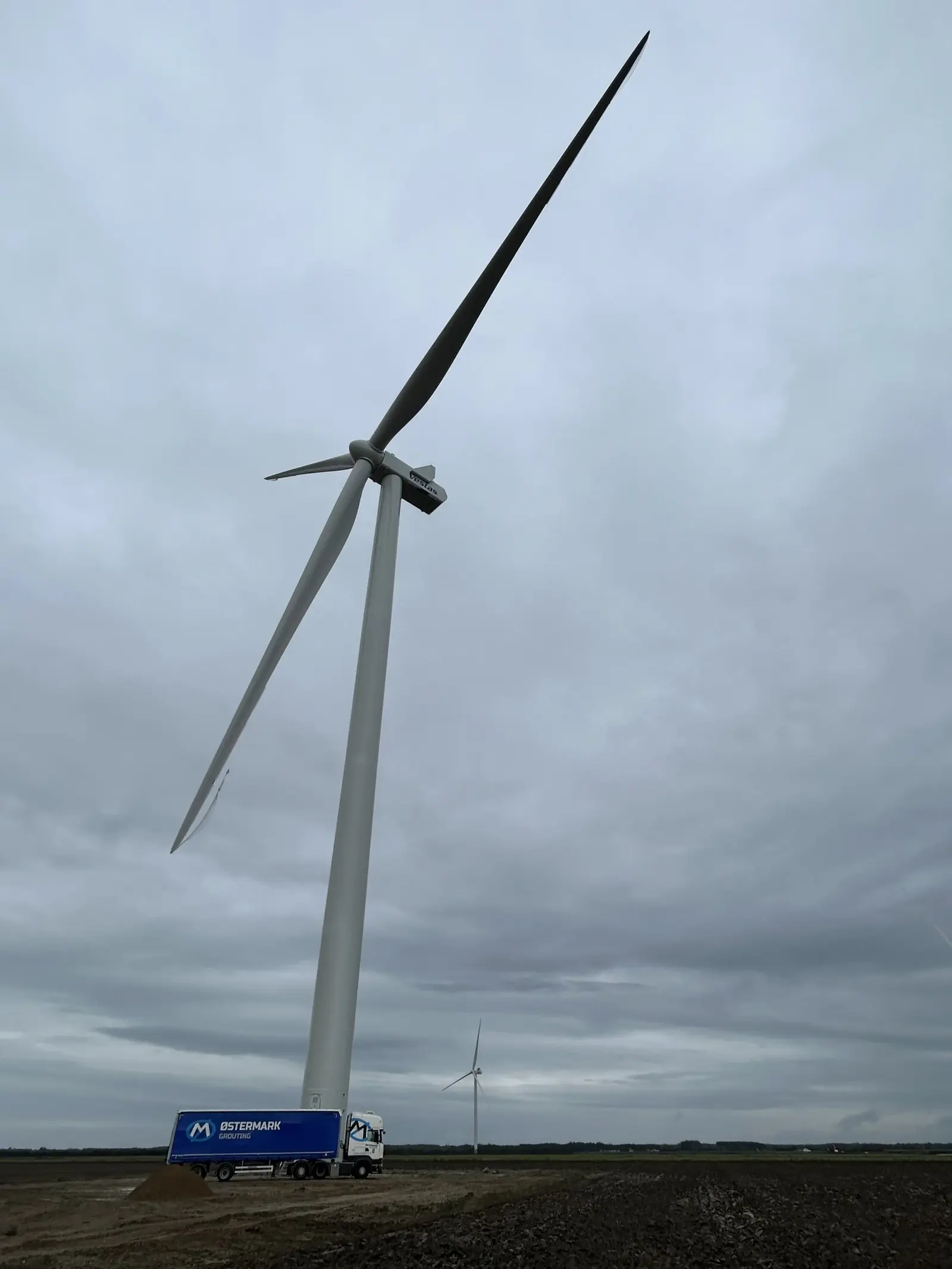 Østermark truck beneath a Vestas turbine